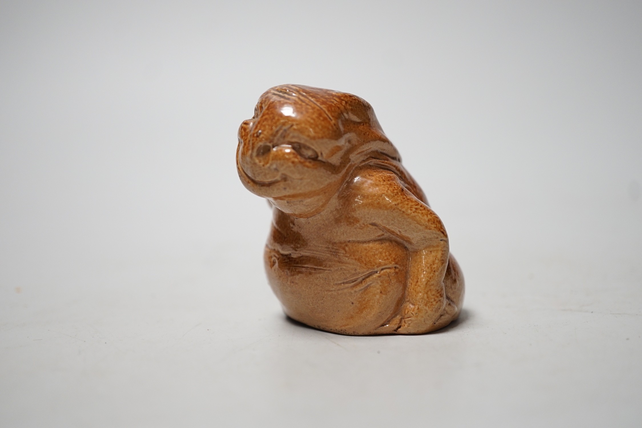 An unusual Royal Doulton salt-glazed stoneware grotesque figure. 6cm tall